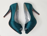 a pair of high heel platform shoes with a peep toe dyed to teal