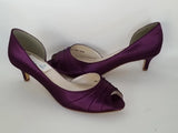 A pair of eggplant purple low heel satin kitten heel shoes with a peep toe