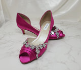 Fuchsia low heel dress shoes with a peep toe and a crystal vine design on the front of the shoes and up the side of the shoes