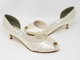 A pair of ivory low heel satin kitten heel shoes with a peep toe