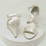 A pair of ivory wedding shoes with high wedge and straps across the front of the foot