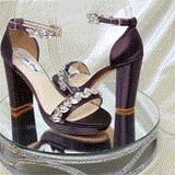 A pair of eggplant purple high block heel platform shoes with an ankle strap and a crystal design on the front toe strap of the shoes and a crystal design on the ankle strap of the shoes