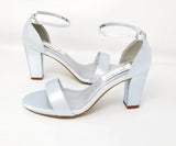 A pair of baby blue block heel shoes with an ankle strap