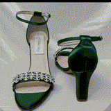 A pair of hunter green block heel shoes with an ankle strap and a crystal design on the front toe strap of the shoes