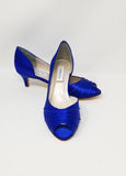 A pair of royal blue satin kitten heel shoes with a peep toe
