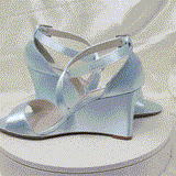 A pair of baby blue wedding shoes with high wedge and straps across the front of the foot