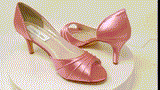 A pair of dusty rose satin medium height heel shoes with a peep toe