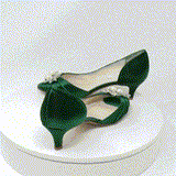 A pair of hunter green satin kitten heels with a peep toe and designed with a crystal and pearl design on the front of the shoes