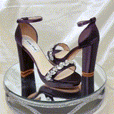 a pair of high heel block shoes dyed eggplant purple with a sparkling crystal design on the front toe strap
