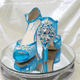 A pair of turquoise high heeled platform lace shoes with an ankle strap and a crystal design on the front of the peep toe shoes and a crystal design on the back heel of the shoes