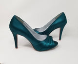 a pair of high heel platform shoes with a peep toe dyed to teal