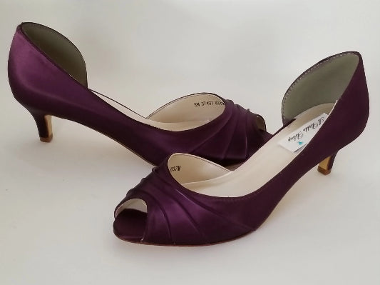 A pair of eggplant purple low heel satin kitten heel shoes with a peep toe