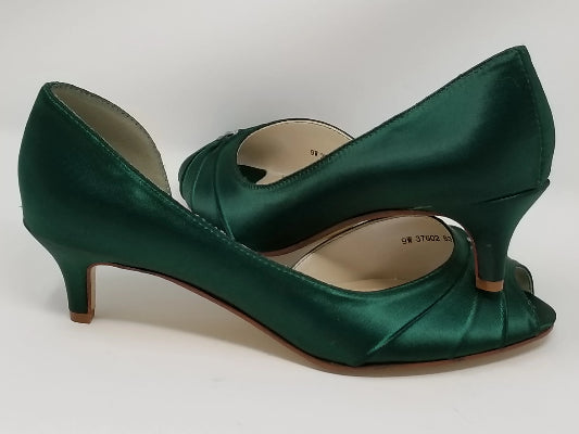 A pair of hunter green low heel satin kitten heel shoes with a peep toe