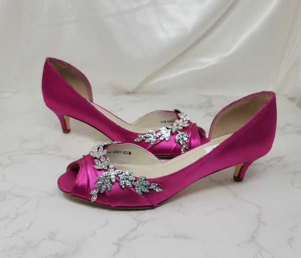 Fuchsia low heel dress shoes with a peep toe and a crystal vine design on the front of the shoes and up the side of the shoes
