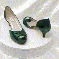 A pair of hunter green low heel satin kitten heel shoes with a peep toe