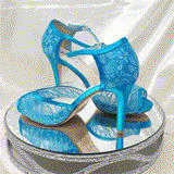 A pair of turquoise lace high heeled shoes with a front hidden platform and an ankle strap with a peep toe