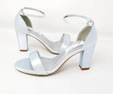 A pair of baby blue block heel shoes with an ankle strap 