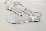 a pair of baby blue flat sandals with a pearl and crystal design on the straps