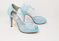 A pair of blue lace high heeled shoes with a front hidden platform and an ankle strap with a peep toe