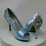 A pair of high heeled baby blue satin shoes with a peep toe and a hidden platform at the front of the shoes and a crystal design on the front of the shoes and a crystal design on the back heel of the shoes
