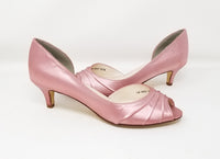A pair of dusty rose low heel satin kitten heel shoes with a peep toe