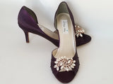 eggplant purple wedding shoes with peep toe and medium heel with a pearl and crystal design on the front of the shoes