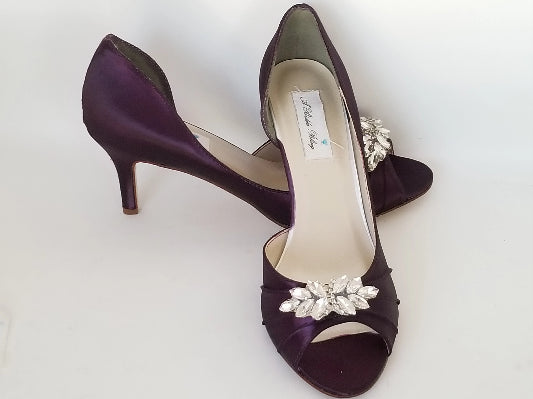 eggplant purple wedding shoes with peep toe and medium heel with a crystal design on the front of the shoes