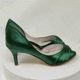 A pair of hunter green satin medium height heel shoes with a peep toe