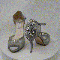 A pair of grey high heeled platform lace shoes with an ankle strap and a crystal design on the front of the peep toe shoe and a crystal design on the back heel of the shoes
