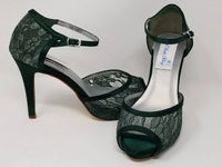 A pair of hunter green lace high heeled shoes with a front hidden platform and an ankle strap with a peep toe