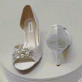 A pair of ivory satin medium height heel shoes with a peep toe and designed with a pearl and crystal design on the front of the shoes