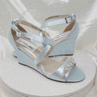 A pair of baby blue wedding shoes with high wedge and straps across the front of the foot designed with a pearl and crystal design on the front toe strap of the shoes