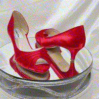 A pair of red satin kitten heel shoes with a peep toe