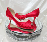 A pair of red satin kitten heel shoes with a peep toe 